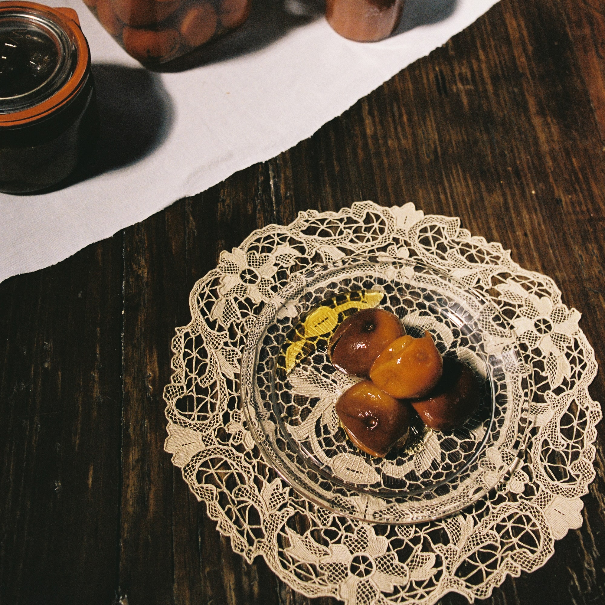 Vintage beige crochet doily styled on a rustic wooden table
