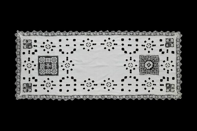 Centenary white linen table runner with lace and openwork.