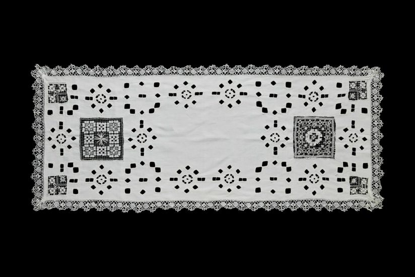 Centenary white linen table runner with lace and openwork.